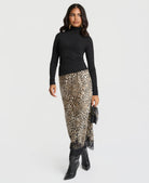 Leopard print satin skirt with black lace trim, styled with a black top and boots